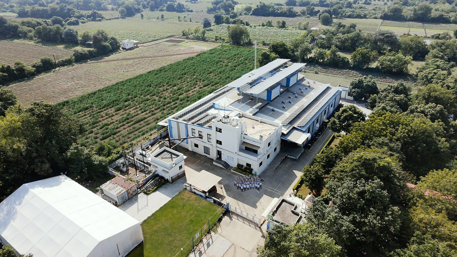 Large facility surrounded by green fields
